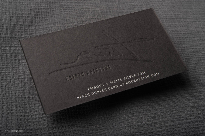 Embossed black business card with matte silver foil details, highlighting premium black duplex card printing by RockDesign.