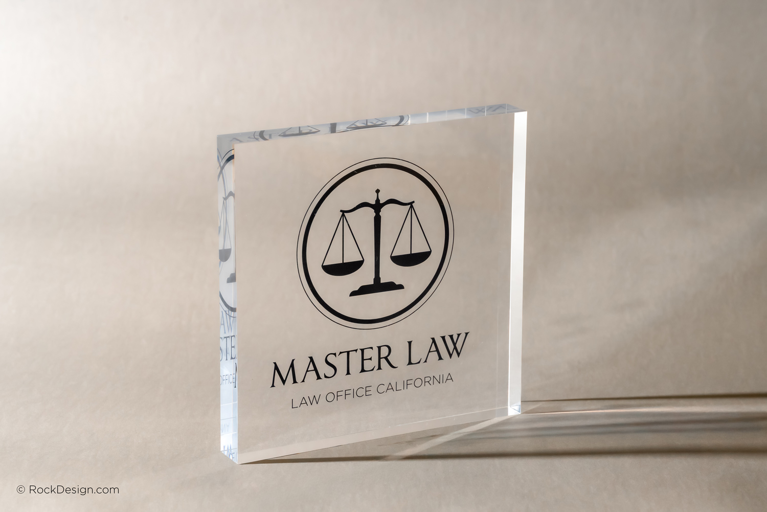 Black UV printed clear acrylic block featuring Master Law logo by RockDesign
